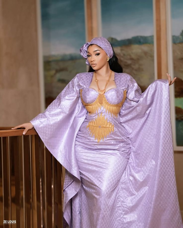 Belle femme habillée avec élégance en bazin violet